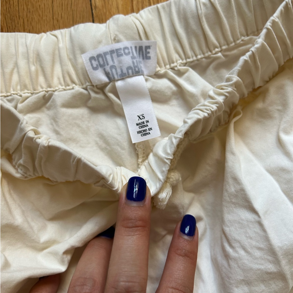 Target Collective Cream/ White with Black Lining Bottoms. Size XS. Fits 26 W